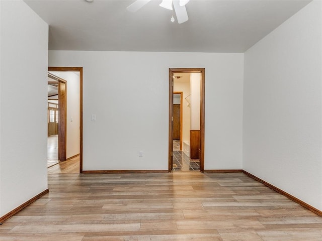 spare room with ceiling fan and light hardwood / wood-style flooring