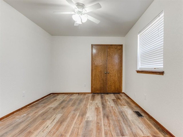 unfurnished bedroom with a closet, ceiling fan, and light hardwood / wood-style flooring