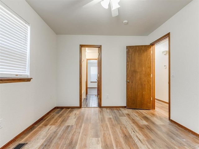 unfurnished bedroom with ceiling fan and light hardwood / wood-style floors