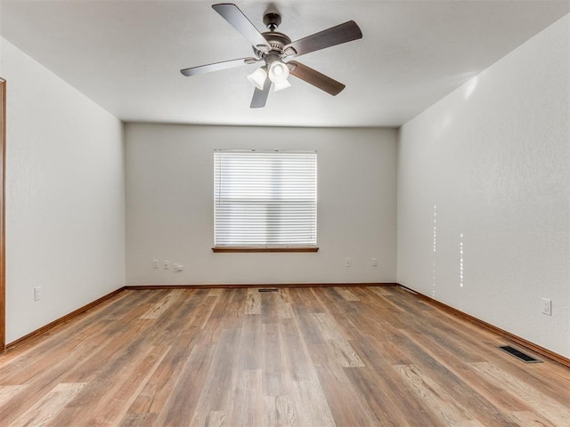 empty room with light hardwood / wood-style flooring and ceiling fan