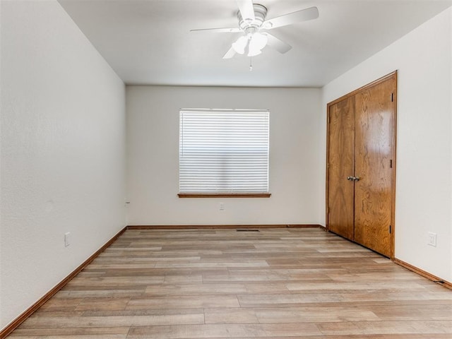 spare room with ceiling fan and light hardwood / wood-style floors