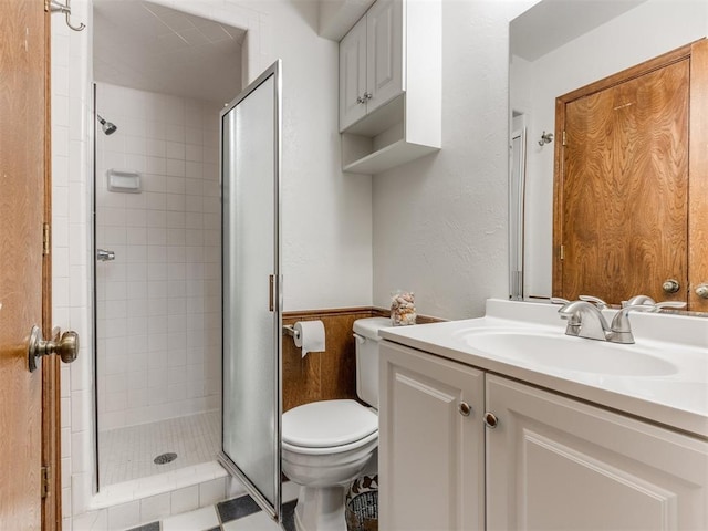 bathroom with vanity, toilet, and a shower with shower door