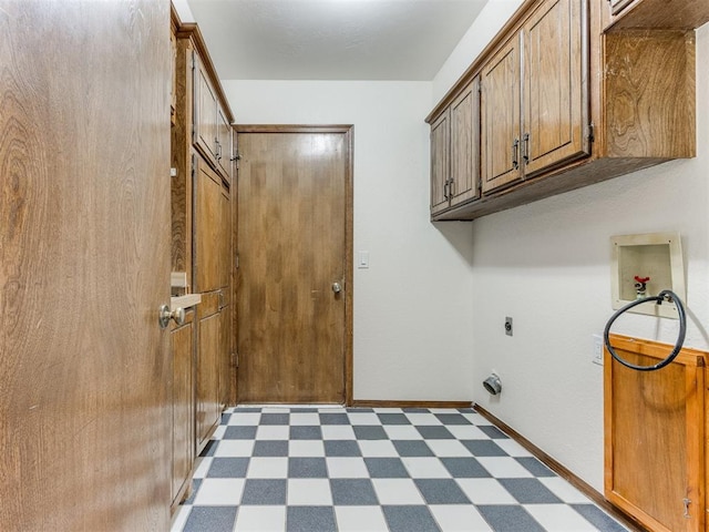 washroom with hookup for an electric dryer, cabinets, and hookup for a washing machine