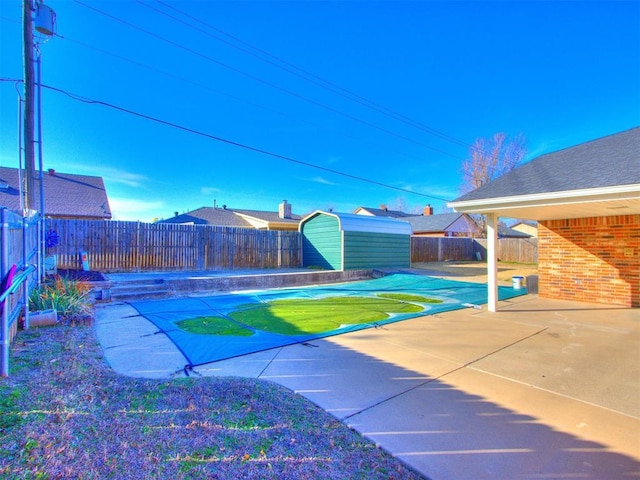 view of yard featuring a patio and a shed