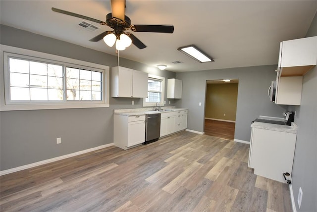 kitchen with white cabinetry, sink, ceiling fan, stainless steel appliances, and light hardwood / wood-style flooring