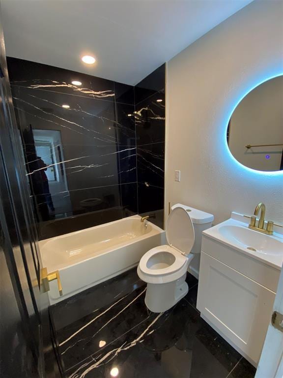 full bathroom featuring vanity, toilet, and tiled shower / bath