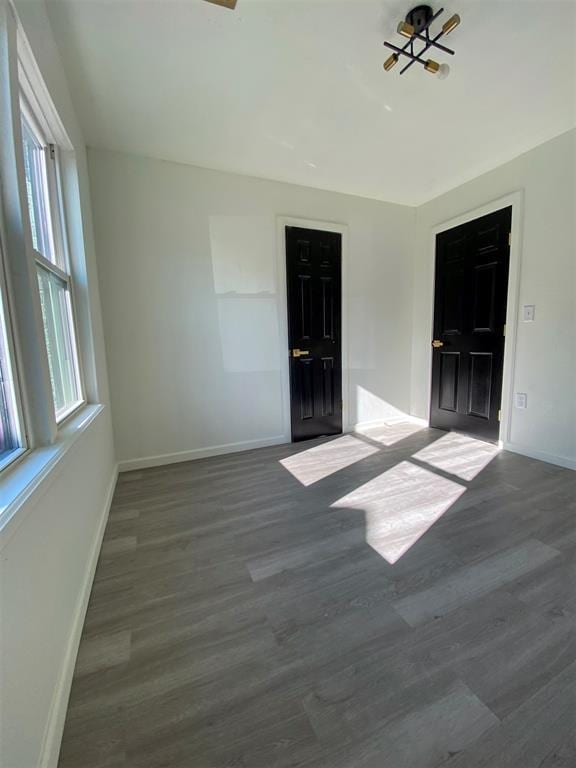 spare room featuring dark hardwood / wood-style floors and ceiling fan