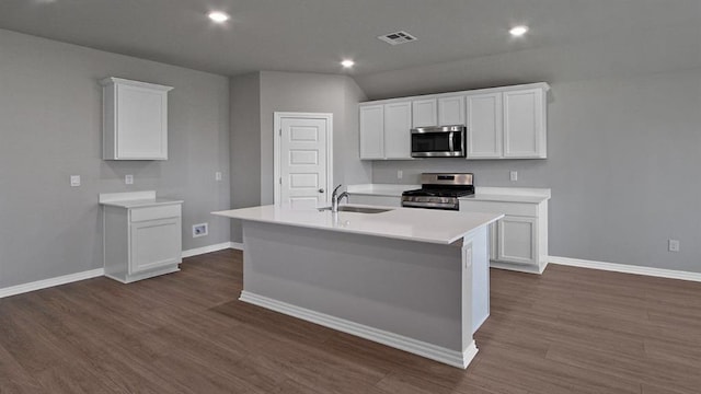 kitchen with visible vents, an island with sink, appliances with stainless steel finishes, light countertops, and a sink