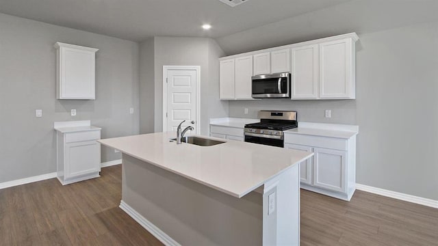 kitchen with stainless steel appliances, white cabinets, light countertops, and a sink