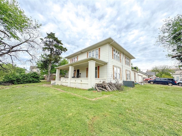 view of home's exterior featuring a lawn, central AC, and covered porch