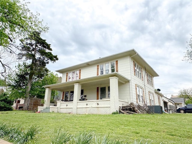 view of front of property with covered porch and a front lawn