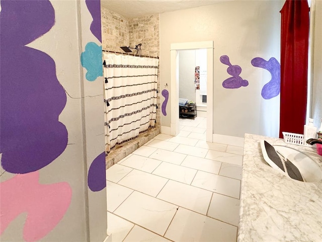 bathroom featuring a shower with shower curtain, tile patterned flooring, and sink