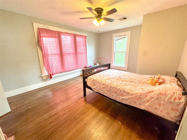 bedroom featuring hardwood / wood-style flooring and ceiling fan