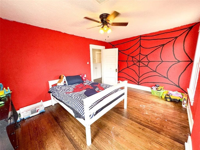 bedroom featuring hardwood / wood-style flooring and ceiling fan