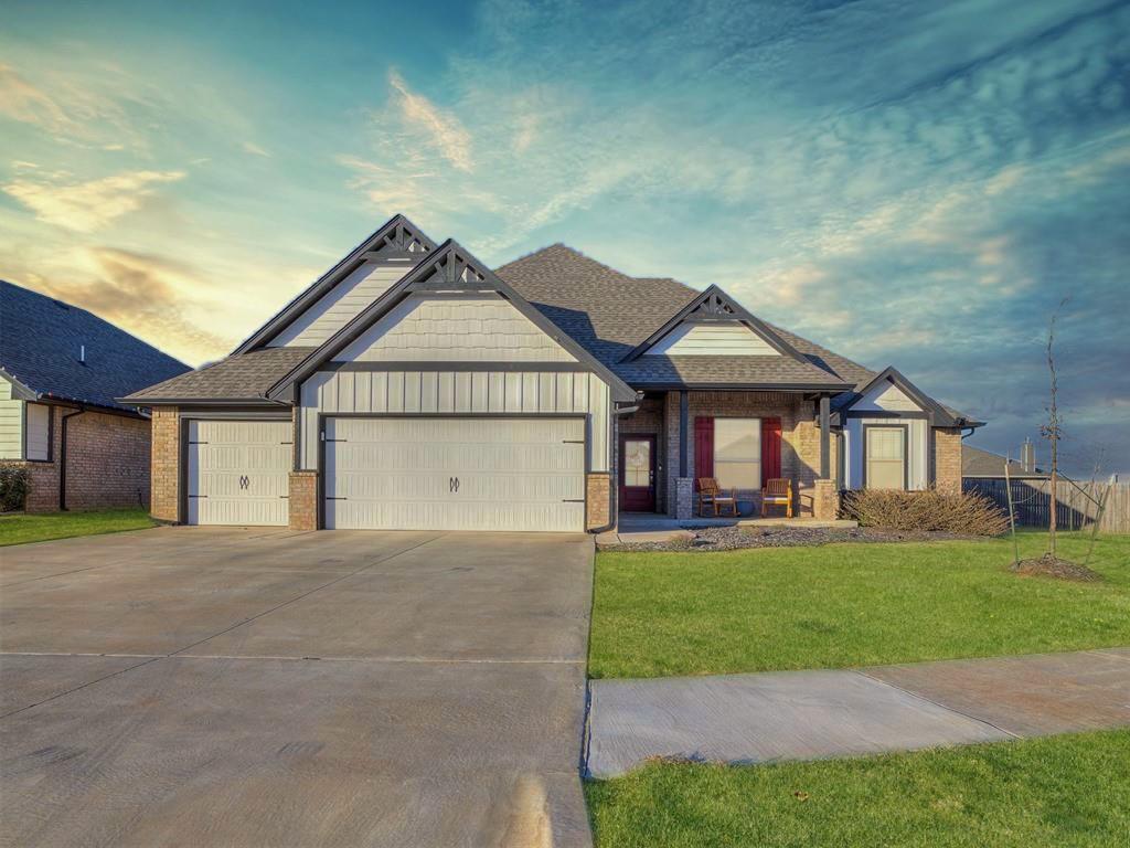 view of front of house with a garage and a lawn