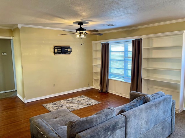 living room with a textured ceiling, ceiling fan, crown molding, and dark hardwood / wood-style floors