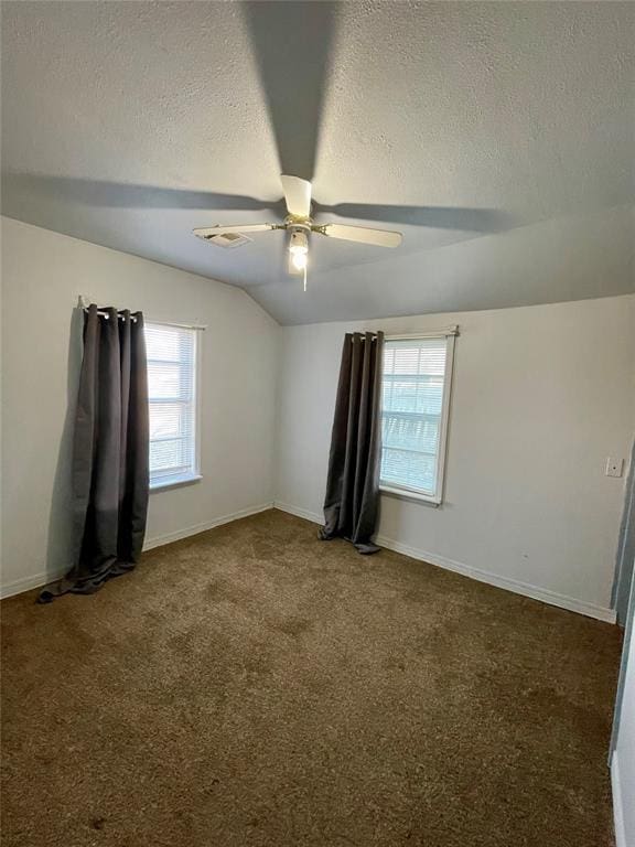 unfurnished room with carpet flooring, a textured ceiling, ceiling fan, and lofted ceiling