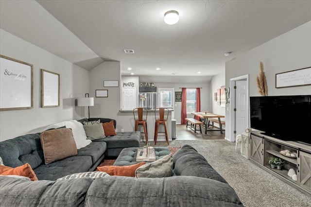 living room featuring carpet flooring and lofted ceiling