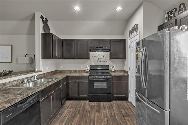 kitchen with vaulted ceiling, sink, black appliances, dark stone countertops, and dark hardwood / wood-style floors