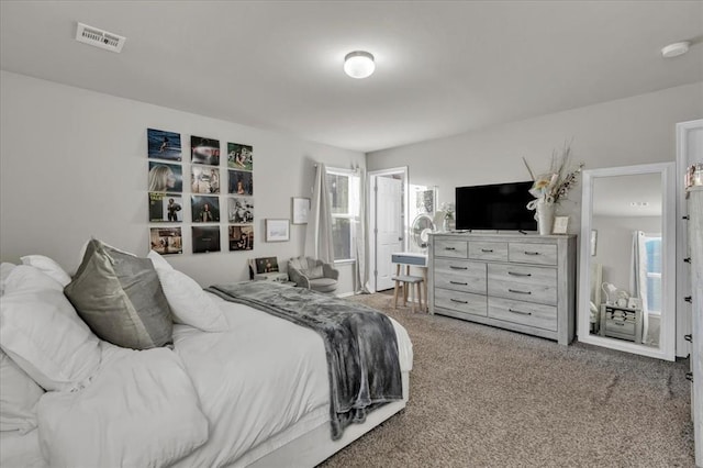 carpeted bedroom featuring multiple windows