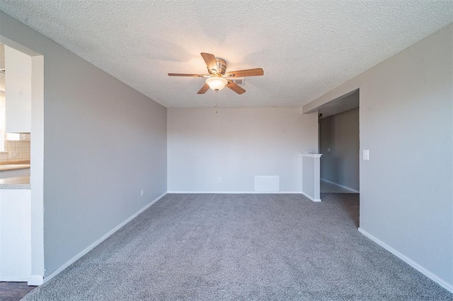 carpeted empty room with a textured ceiling and ceiling fan