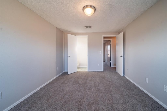 unfurnished bedroom featuring carpet floors and a textured ceiling