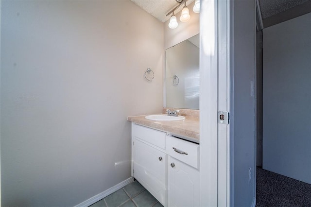 bathroom featuring tile patterned floors, vanity, and a textured ceiling