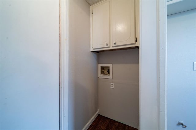 laundry room with dark hardwood / wood-style flooring, hookup for a washing machine, and cabinets