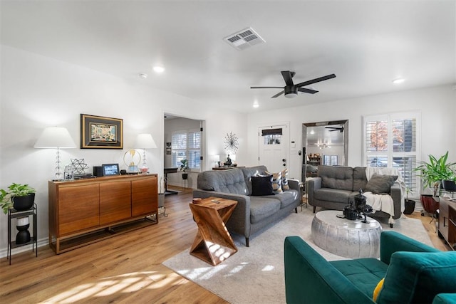 living room featuring plenty of natural light, ceiling fan, and light hardwood / wood-style floors