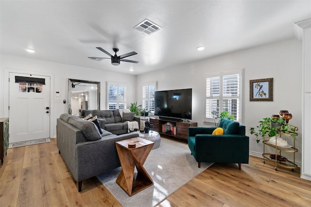 living room featuring ceiling fan and light wood-type flooring