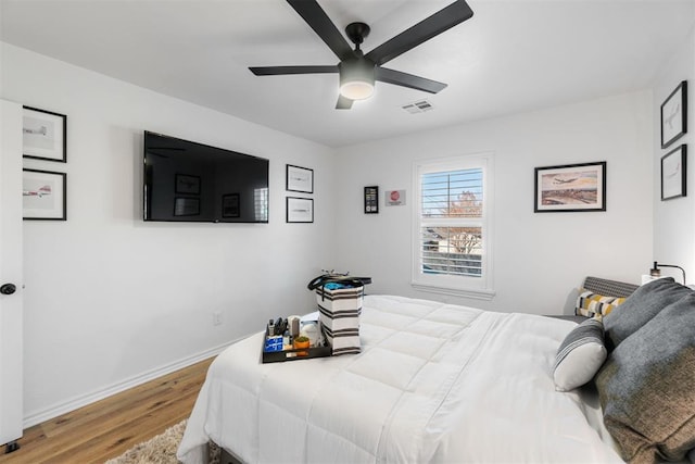 bedroom with ceiling fan and wood-type flooring