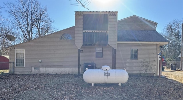 view of home's exterior featuring central AC and a chimney