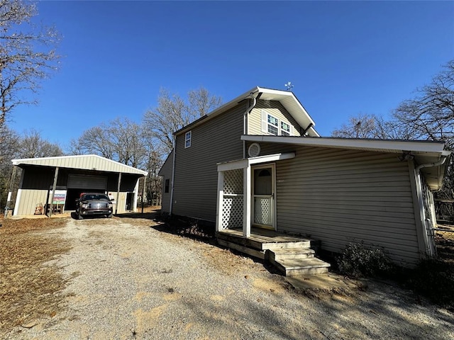 exterior space with a garage, an outdoor structure, and a carport