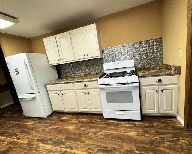 kitchen featuring dark wood-type flooring, white cabinetry, tasteful backsplash, white appliances, and dark stone counters