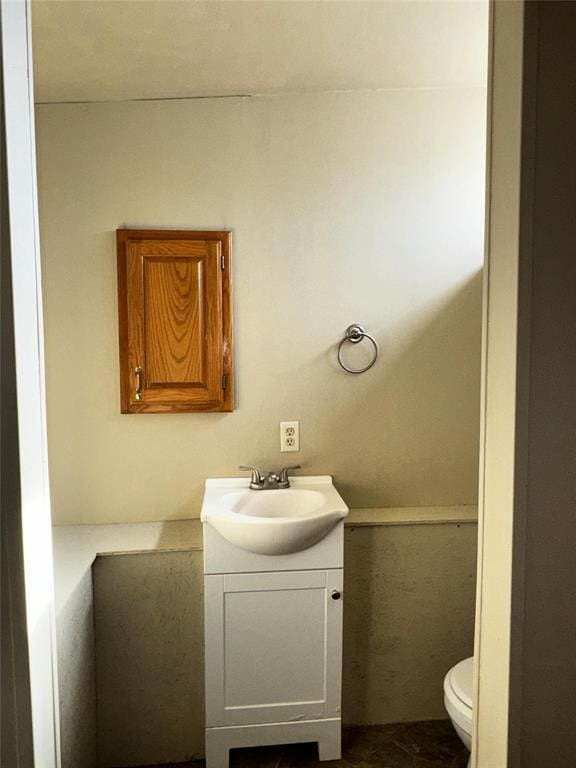 bathroom featuring vanity and toilet