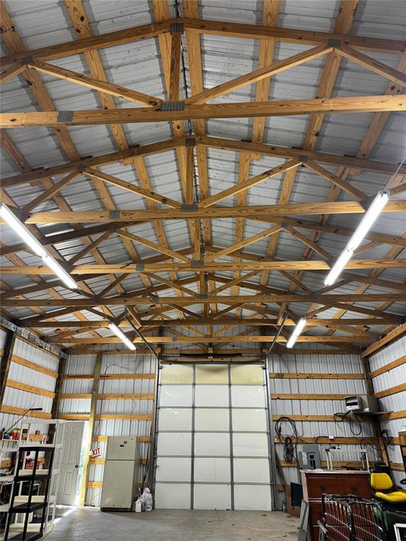 garage with metal wall and freestanding refrigerator