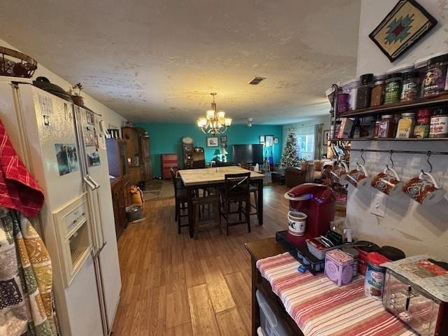 dining space featuring a chandelier and wood finished floors