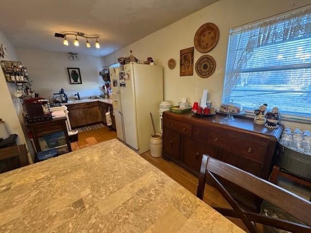 kitchen featuring light countertops, light wood finished floors, and freestanding refrigerator