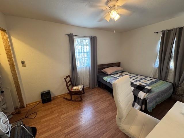 bedroom featuring a ceiling fan and wood finished floors