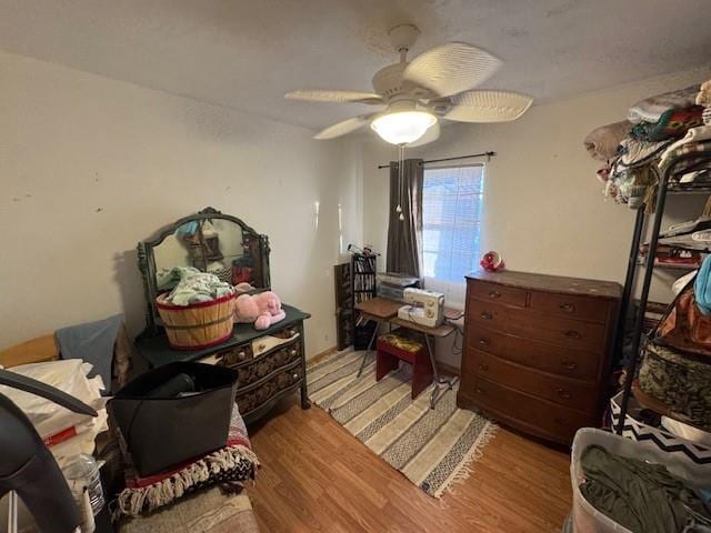 bedroom featuring a ceiling fan and wood finished floors