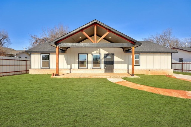 rear view of house featuring a lawn and a patio area