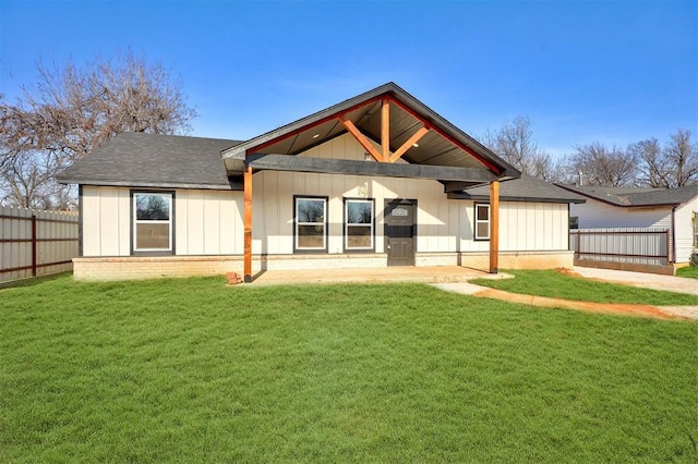 rear view of property featuring a yard