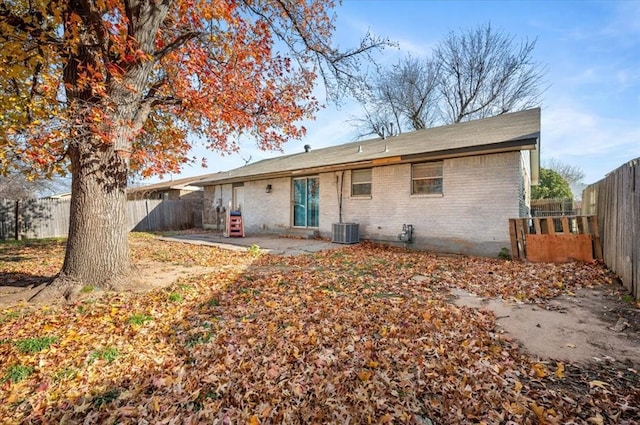 rear view of property with a patio area and cooling unit