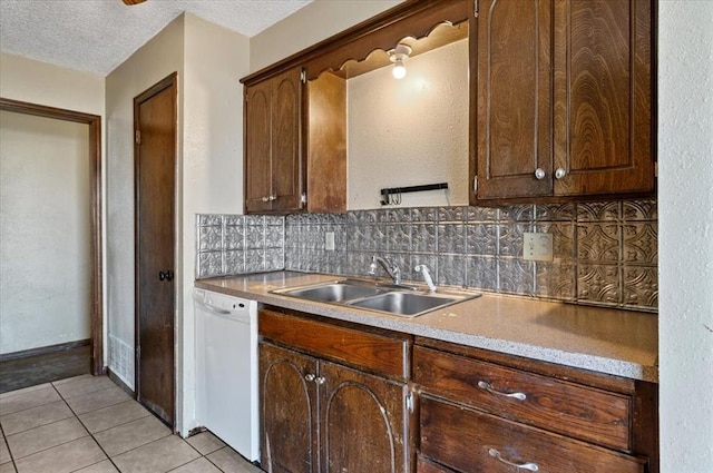 kitchen with dishwasher, decorative backsplash, light tile patterned flooring, and sink