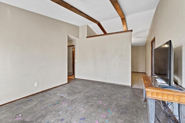 unfurnished living room featuring lofted ceiling with beams and a textured ceiling