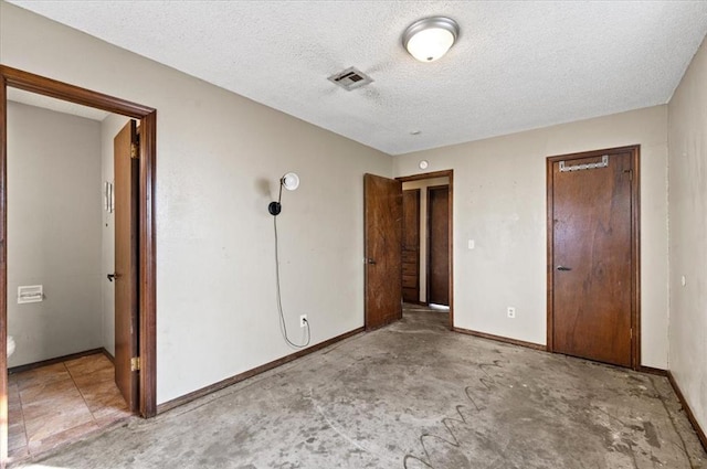 unfurnished bedroom featuring a textured ceiling