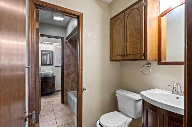 full bathroom with tile patterned flooring, vanity, toilet, and tiled shower / bath