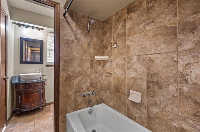 bathroom featuring vanity and tiled shower / bath