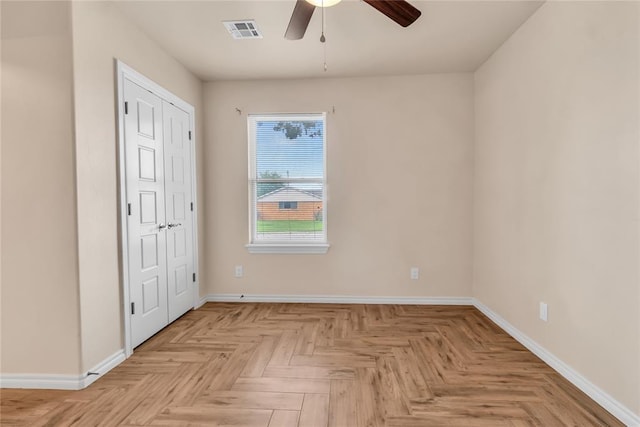 interior space with light parquet flooring and ceiling fan