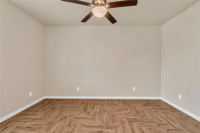 unfurnished room with ceiling fan and light parquet floors